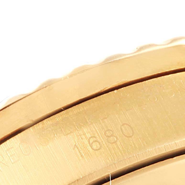 The image shows a close-up of the side bezel with part number engraving of the Rolex Vintage Collection 1680 Men's Yellow Gold Blue Dial 1680 Men's Yellow Gold Blue Dial model 1680.