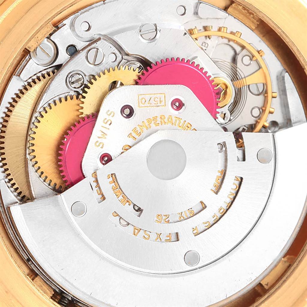 The image shows an internal mechanism of a Vintage Collection model Rolex watch, revealing gears and intricate components.