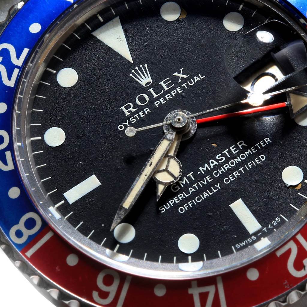 This close-up image shows the dial and bezel of the Rolex Vintage Collection 1675 Men's Stainless Steel Black Dial 1675 Men's Stainless Steel Black Dial GMT-Master watch, highlighting the hour markers and hands.