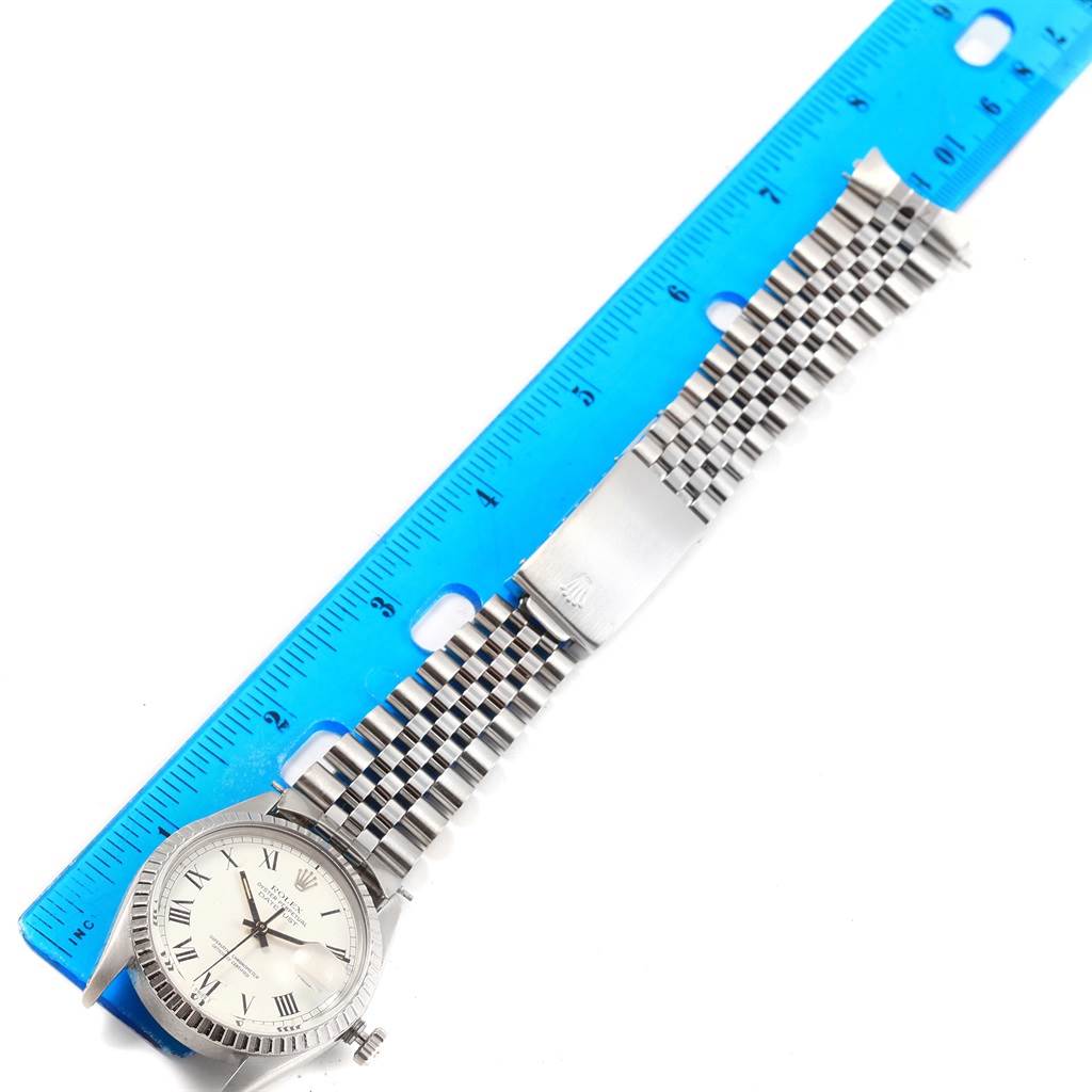 The image shows a flat-lay view of a Rolex Vintage Collection 16030 Men
s Stainless Steel White Dial 16030 Men
s Stainless Steel White Dial watch beside a blue ruler for scale.