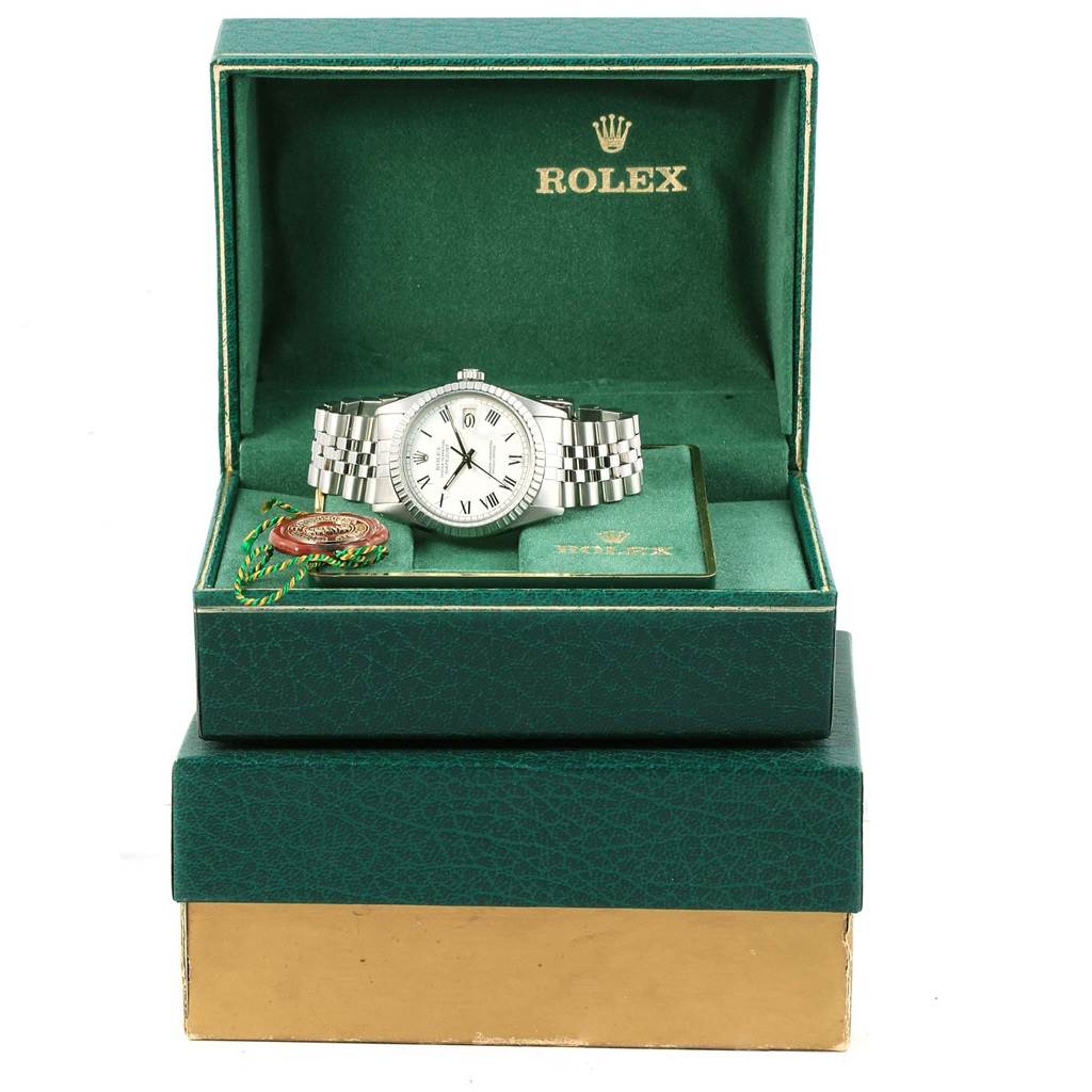 The Vintage Collection Rolex watch is shown from the front, displayed inside its green box with the lid open.
