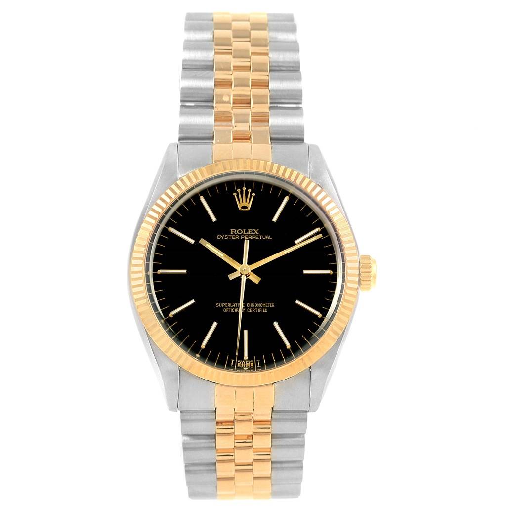The Vintage Collection Rolex watch is shown from the front, highlighting the black dial, gold bezel, and two-tone metal bracelet.