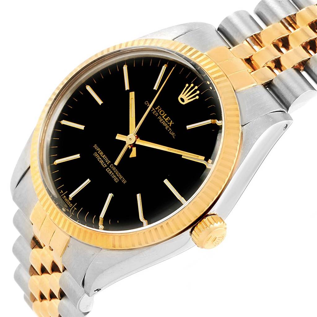 This image shows a close-up of a Rolex Vintage Collection 1005 Men's Steel and Gold (two tone) Black Dial 1005 Men's Steel and Gold (two tone) Black Dial watch displaying the dial, fluted bezel, crown, and part of the two-tone bracelet.