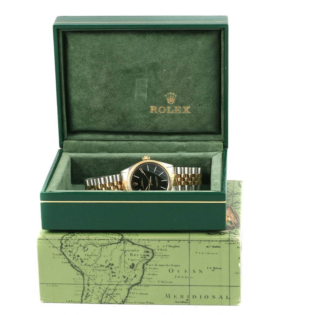 The image shows a Rolex Vintage Collection 1005 Men's Steel and Gold (two tone) Black Dial 1005 Men's Steel and Gold (two tone) Black Dial watch in its original green box, featuring a two-tone metal bracelet and black dial.
