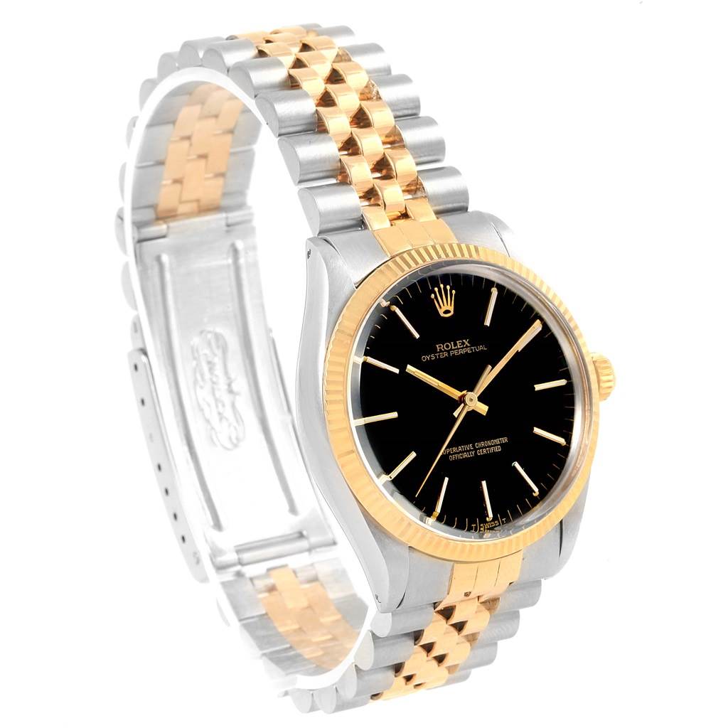 This image shows a side-angle view of a Rolex Vintage Collection 1005 Men's Steel and Gold (two tone) Black Dial 1005 Men's Steel and Gold (two tone) Black Dial watch, highlighting its gold and silver bracelet and black dial.