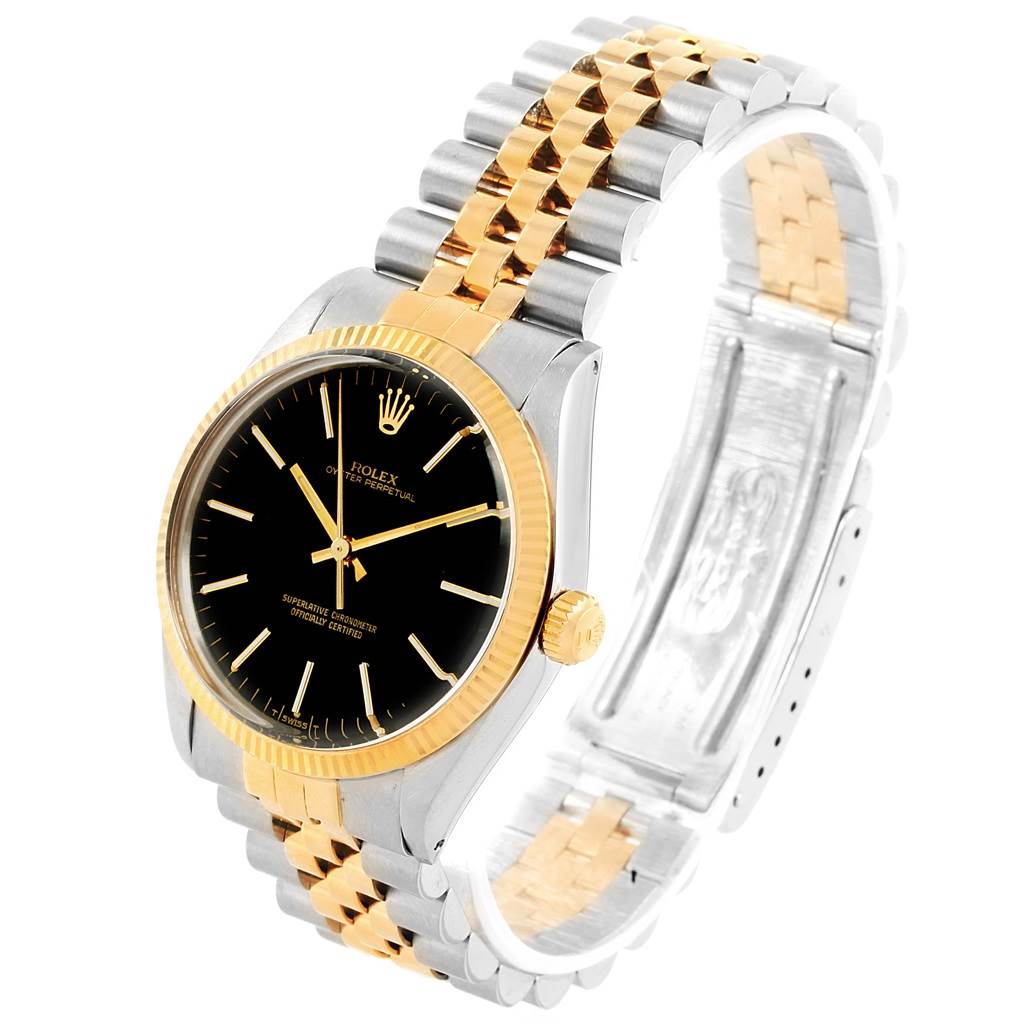 This image shows a Rolex Vintage Collection 1005 Men's Steel and Gold (two tone) Black Dial 1005 Men's Steel and Gold (two tone) Black Dial watch at a three-quarter angle, displaying its black dial, gold bezel, crown, and two-tone bracelet.
