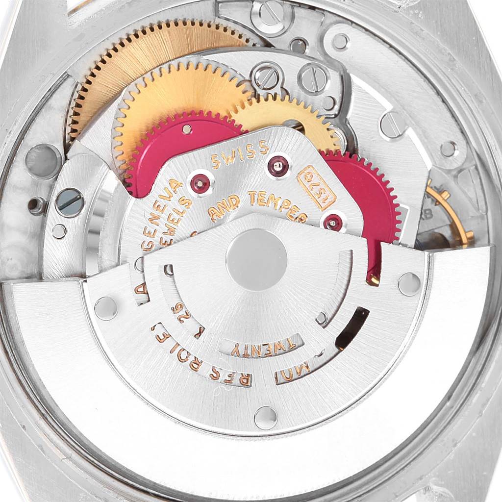 This close-up shows the intricate internal mechanism of the Rolex Vintage Collection 1005 Men's Steel and Gold (two tone) White Dial 1005 Men's Steel and Gold (two tone) White Dial watch, featuring gears and engraved parts.