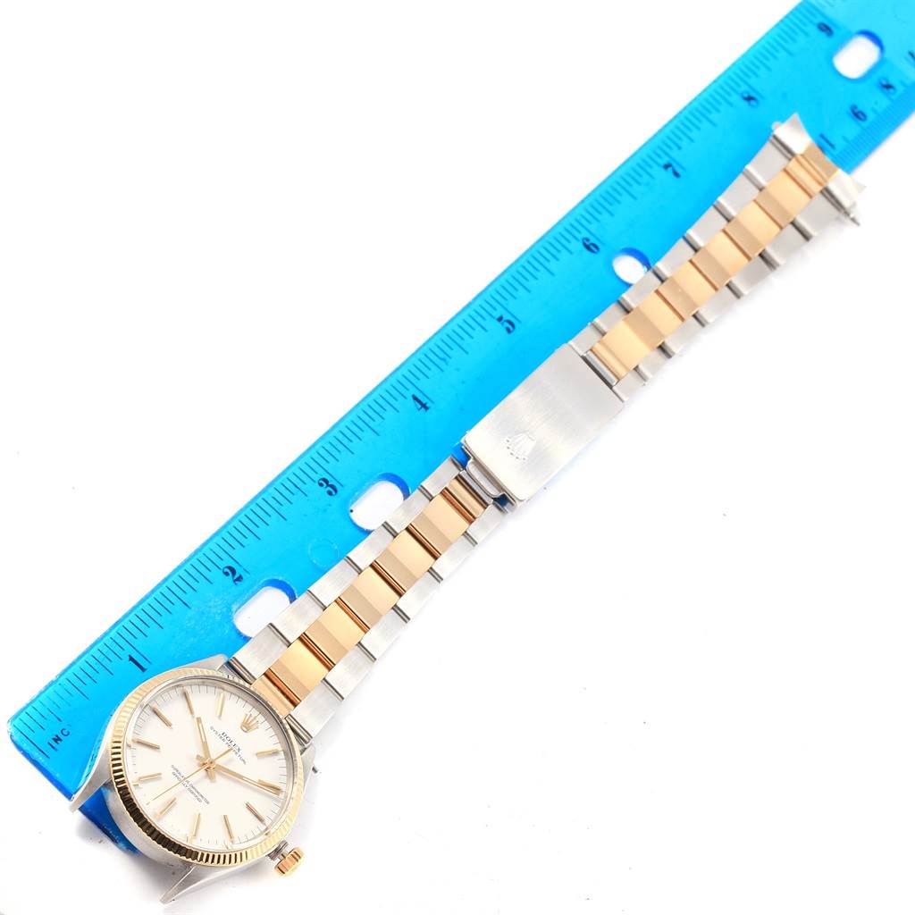 A top-down view of the Rolex Vintage Collection 1005 Men's Steel and Gold (two tone) White Dial 1005 Men's Steel and Gold (two tone) White Dial watch showing the face, bezel, crown, and two-tone bracelet, measured against a ruler.