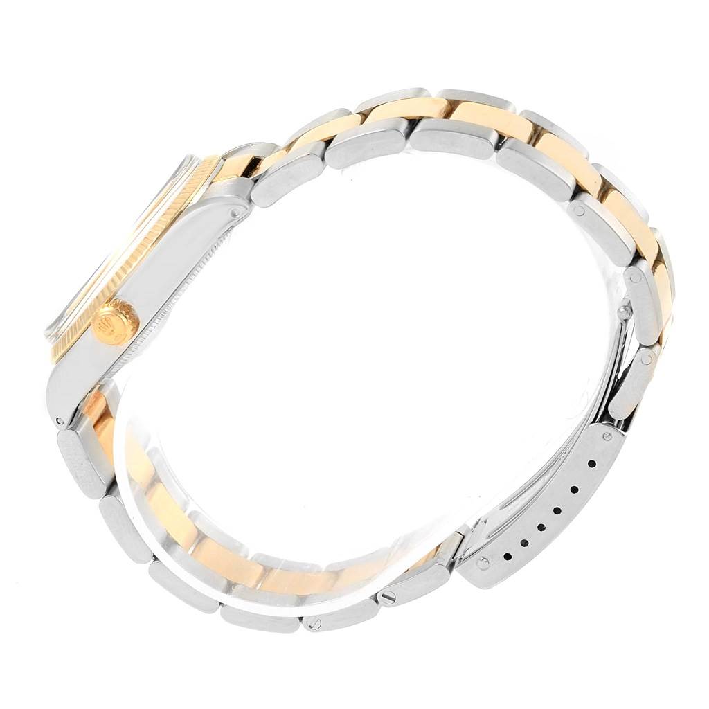 The side view of the watch shows the casing, crown, and two-tone metal bracelet of the Vintage Collection model by Rolex.