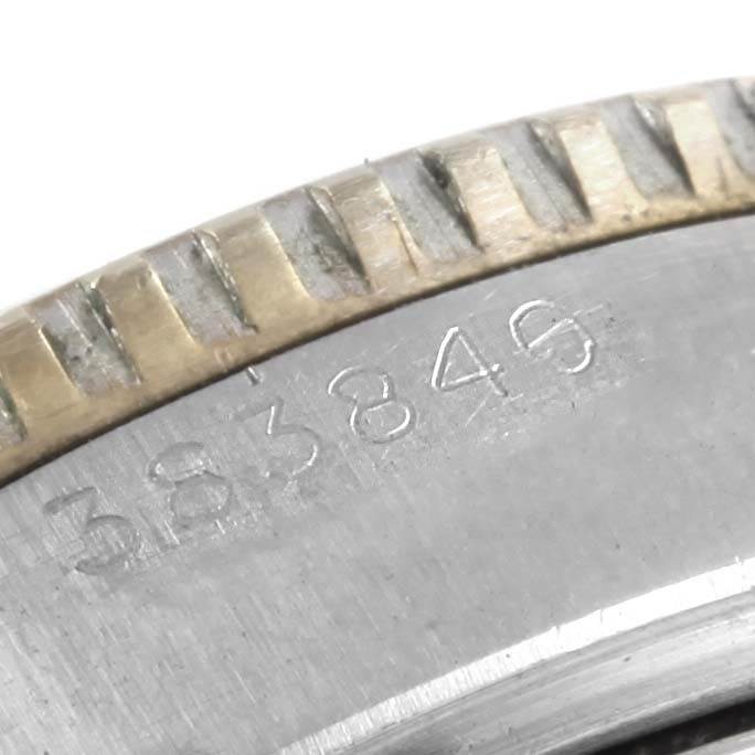 This close-up image of the Rolex Vintage Collection 6538 Men's Stainless Steel Black Dial 6538 Men's Stainless Steel Black Dial watch shows the serial number engraved on the case edge next to the bezel.