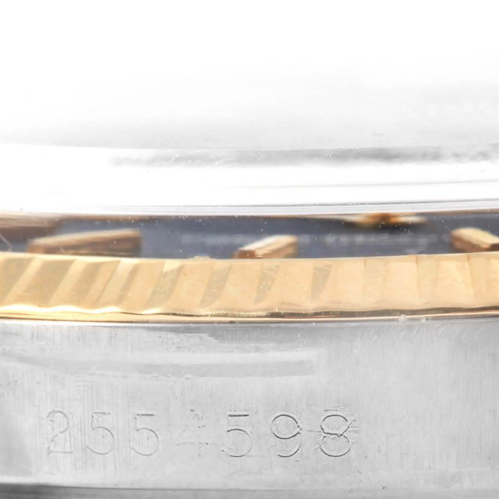 This image shows a close-up of the serial number and fluted bezel on a Rolex Vintage Collection 1600 Men's Stainless Steel Black Dial 1600 Men's Stainless Steel Black Dial model watch.