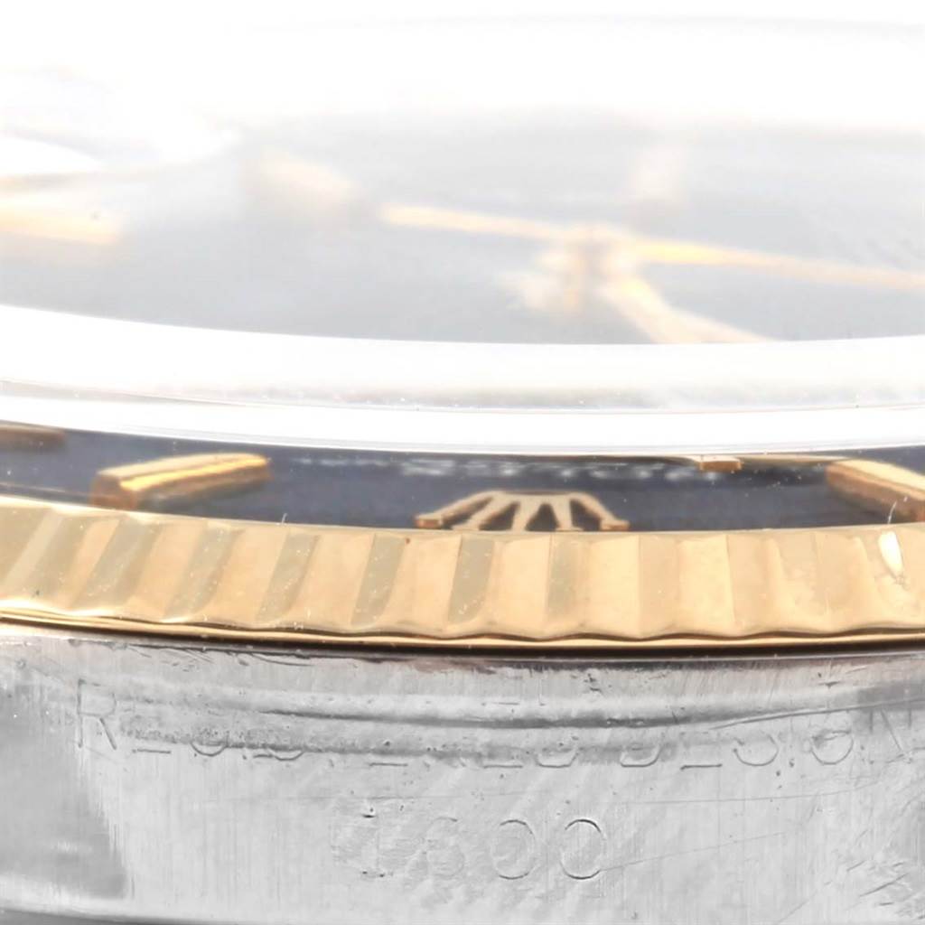 The image shows a close-up, side view of the bezel and part of the dial of the Rolex Vintage Collection 1600 Men's Stainless Steel Black Dial 1600 Men's Stainless Steel Black Dial model watch.