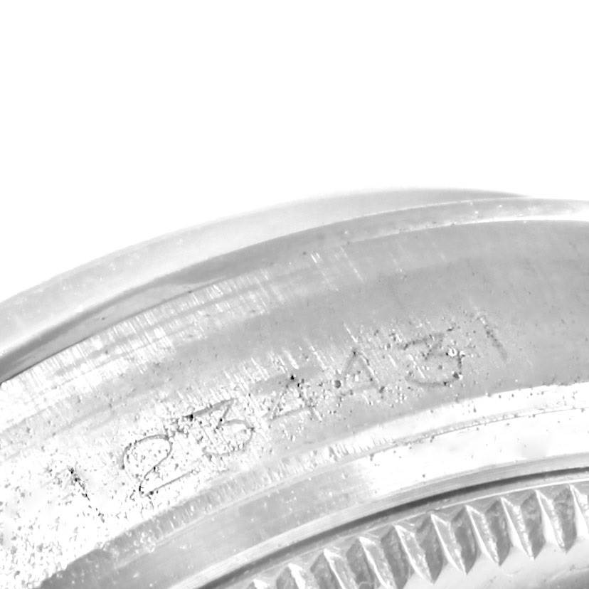 The image shows a close-up of the serial number engraving on the case of a Vintage Collection model by Rolex.