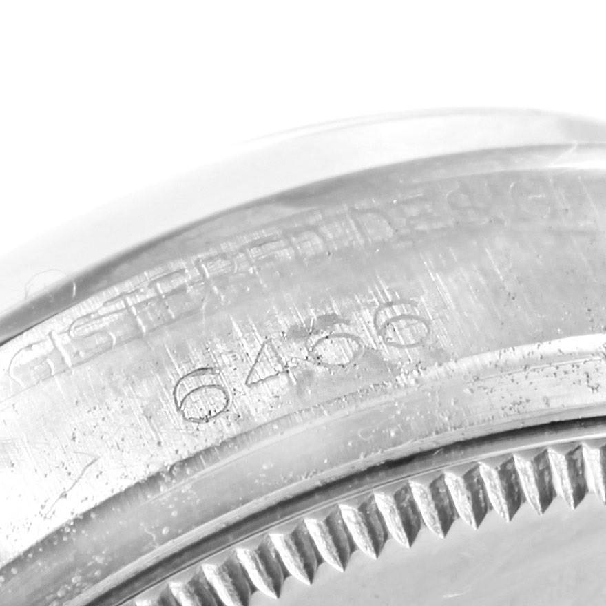 The image shows a close-up of the engraved serial number on the bezel of a Rolex Vintage Collection 6466 Men's Stainless Steel Silver Dial 6466 Men's Stainless Steel Silver Dial model watch.