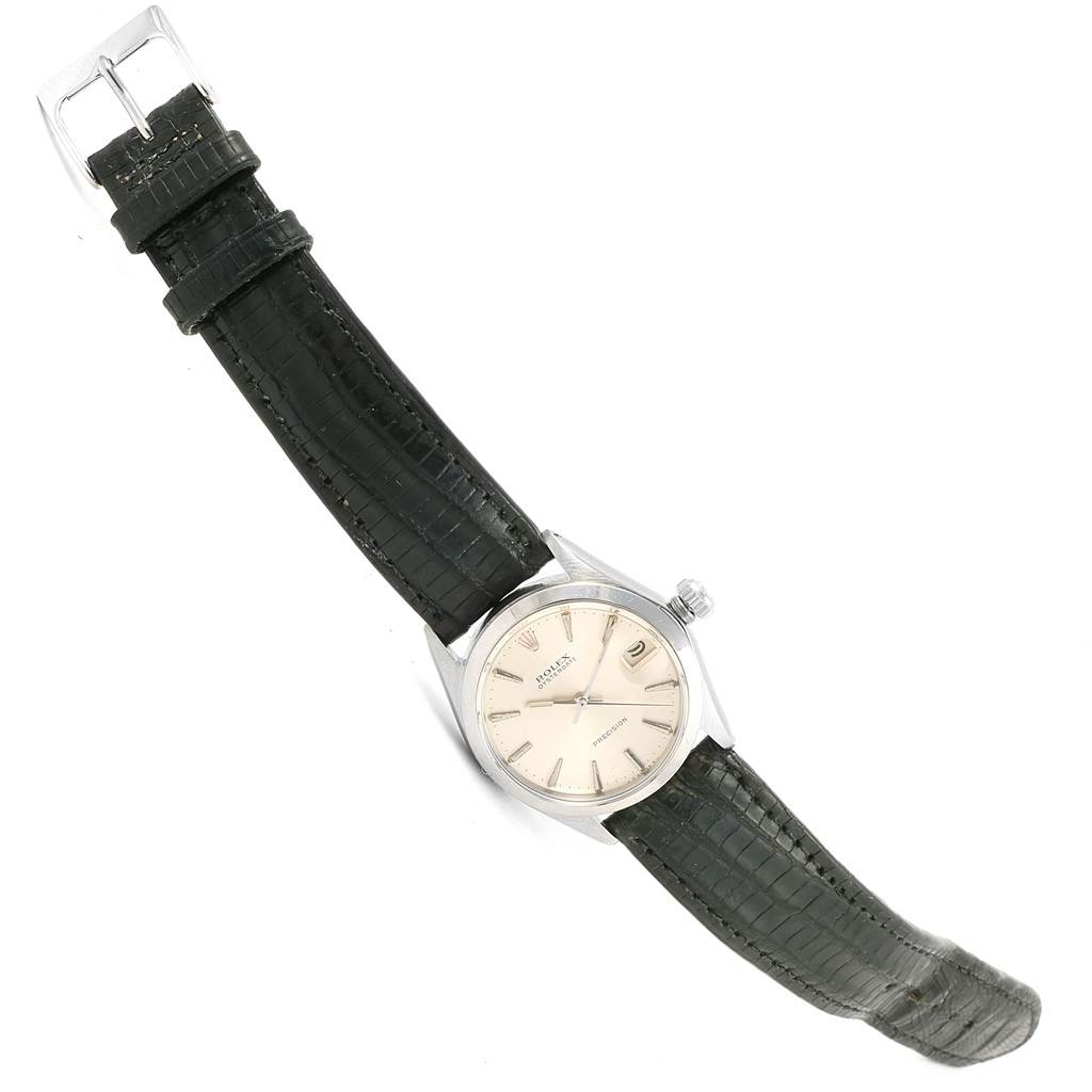 The image shows a Rolex Vintage Collection 6466 Men's Stainless Steel Silver Dial 6466 Men's Stainless Steel Silver Dial watch at a tilted angle, displaying its face, case, strap, and buckle.