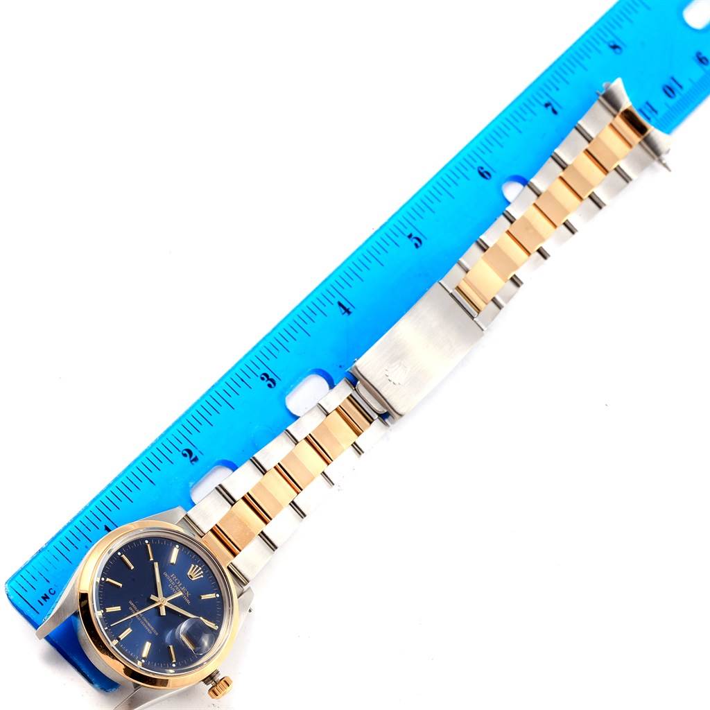 The image shows a top-down view of a Rolex Vintage Collection 15003 Men's Steel and Gold (two tone) Blue Dial 15003 Men's Steel and Gold (two tone) Blue Dial watch laying beside a blue ruler for measurement.