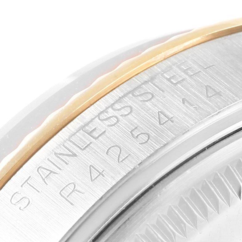 This close-up of the Rolex Vintage Collection 5701 Men's Steel and Gold (two tone) Champagne Dial 5701 Men's Steel and Gold (two tone) Champagne Dial watch showcases part of the bezel and the "STAINLESS STEEL" engraving.