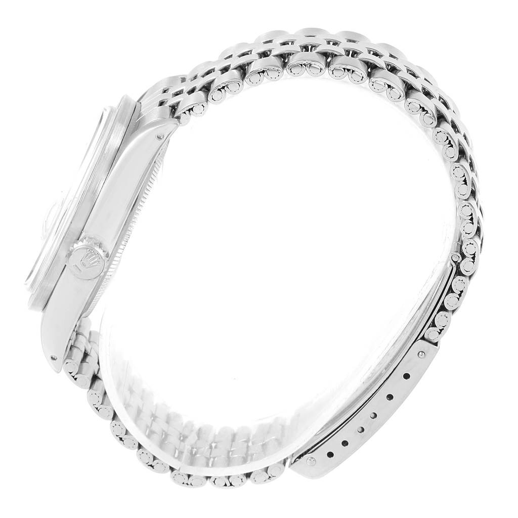 The image shows a side view of a Rolex Vintage Collection 1501 Stainless Steel Silver Dial 1501 Stainless Steel Silver Dial watch, highlighting its band, crown, and part of the case.