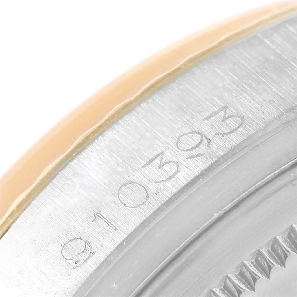 This image shows a close-up of the side of the bezel and case of a Vintage Collection Rolex watch.
