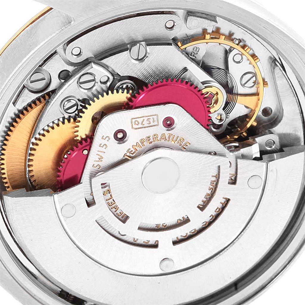 This image shows a close-up view of the intricate inner mechanisms of a Rolex Vintage Collection 1500 Men's Stainless Steel Brown Dial 1500 Men's Stainless Steel Brown Dial watch.