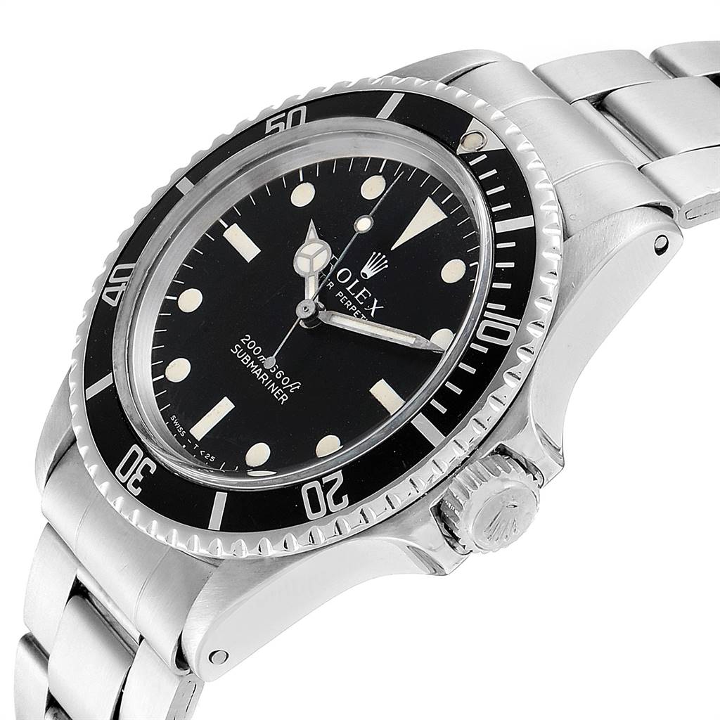 The image shows a Rolex Vintage Collection 5513 Men
s Stainless Steel Black Dial 5513 Men
s Stainless Steel Black Dial Submariner watch at an angled close-up, featuring the face, bezel, crown, and part of the bracelet.