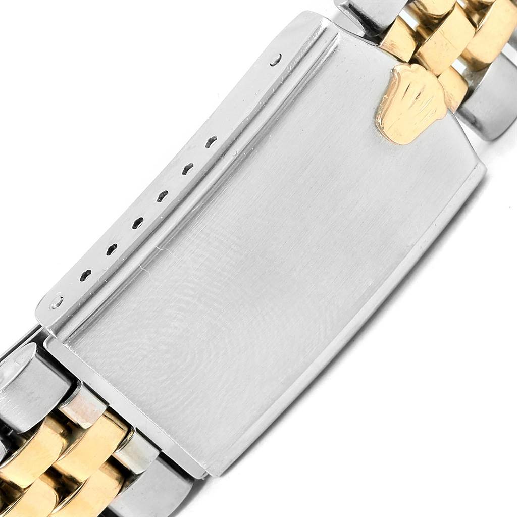 This image shows a close-up of the clasp on the band of a Vintage Collection Rolex watch, highlighting the two-tone metal design.