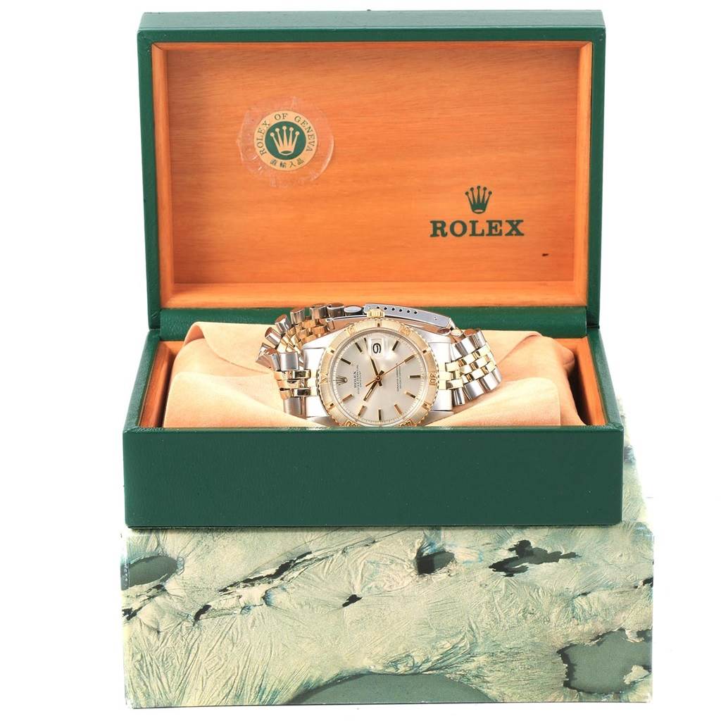 The image shows a Vintage Collection Rolex watch displayed in its open green and wooden box, highlighting the watch face and bracelet.