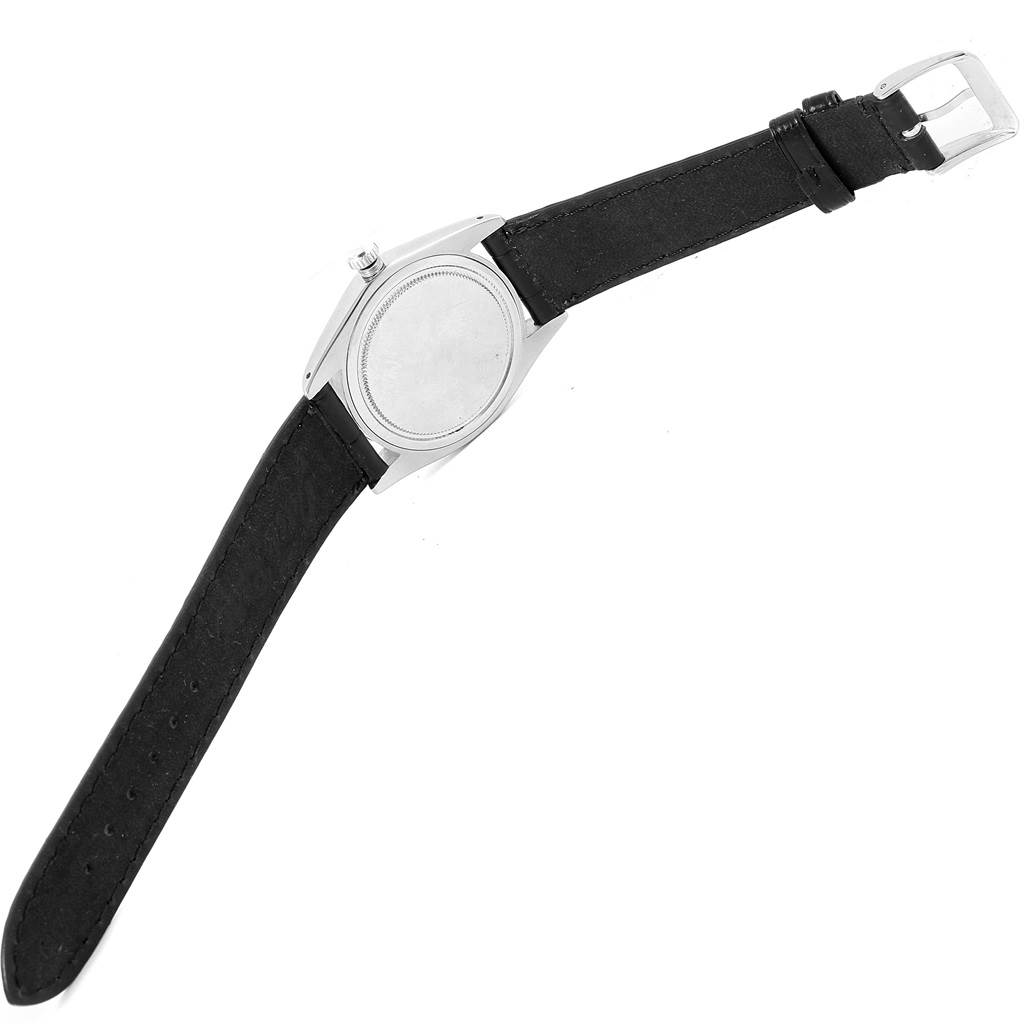 The image shows the back view of a Vintage Collection model Rolex watch, highlighting its case and black leather strap.