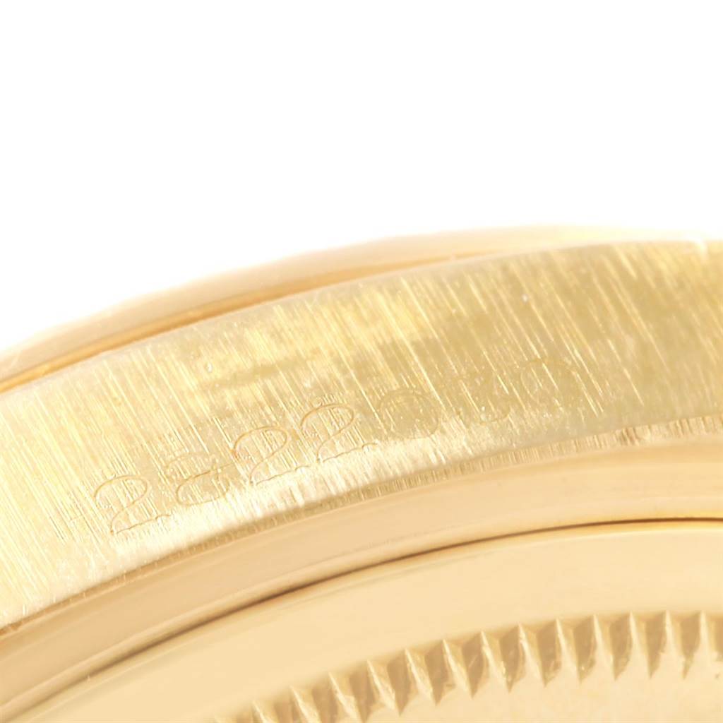 This close-up image of the Rolex Vintage Collection 1807 Men's Yellow Gold Champagne Dial 1807 Men's Yellow Gold Champagne Dial model shows the engraved serial number on the gold watch case.