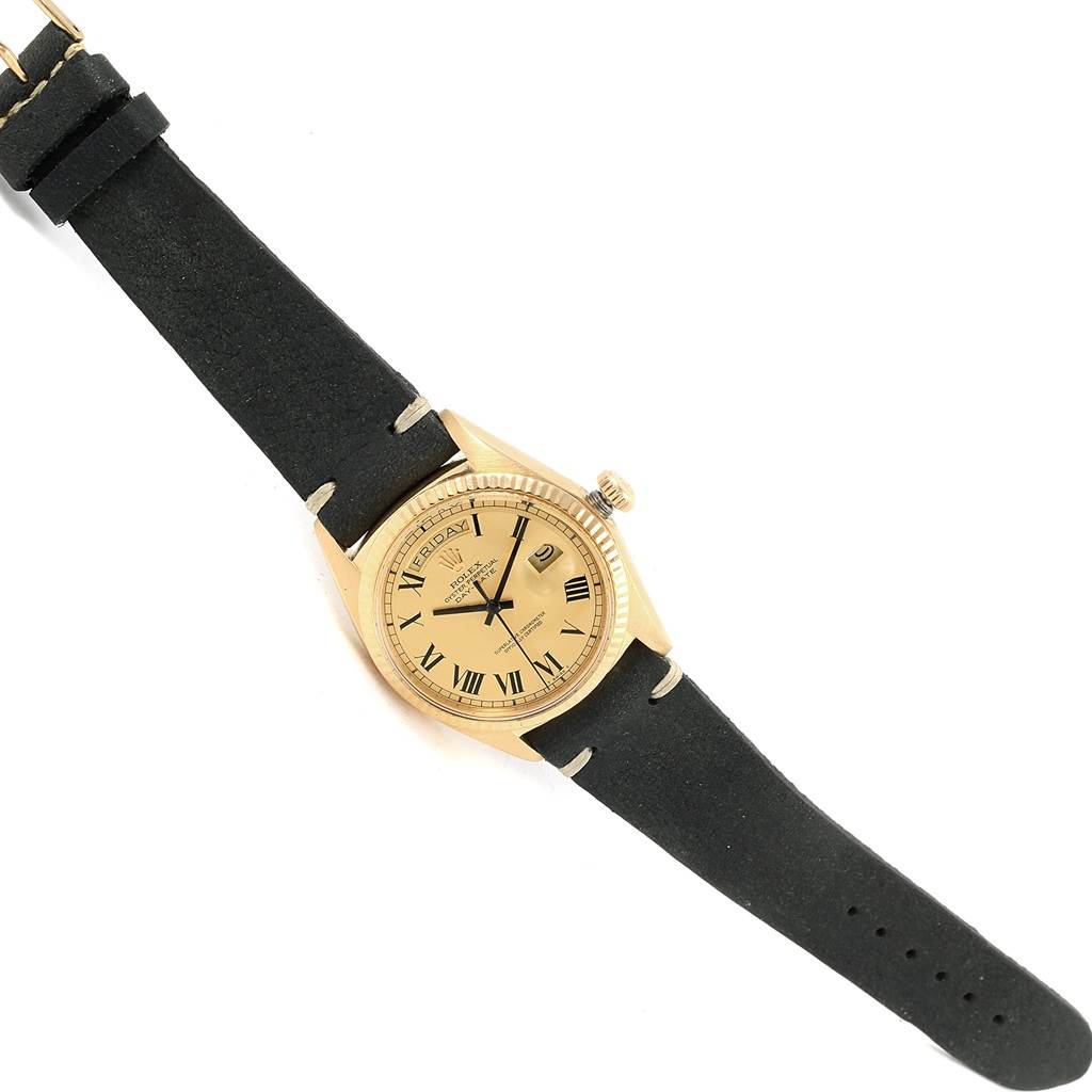 The image shows a top-down view of a Vintage Collection Rolex watch, displaying its dial, case, crown, and black leather strap.