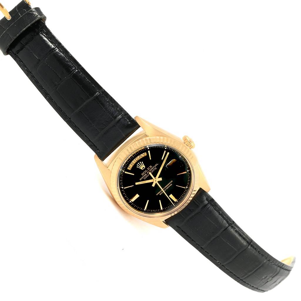 The Rolex Vintage Collection 1803 Men's Yellow Gold Black Dial 1803 Men's Yellow Gold Black Dial model watch is shown at a slight angle, displaying its black leather strap and gold case.