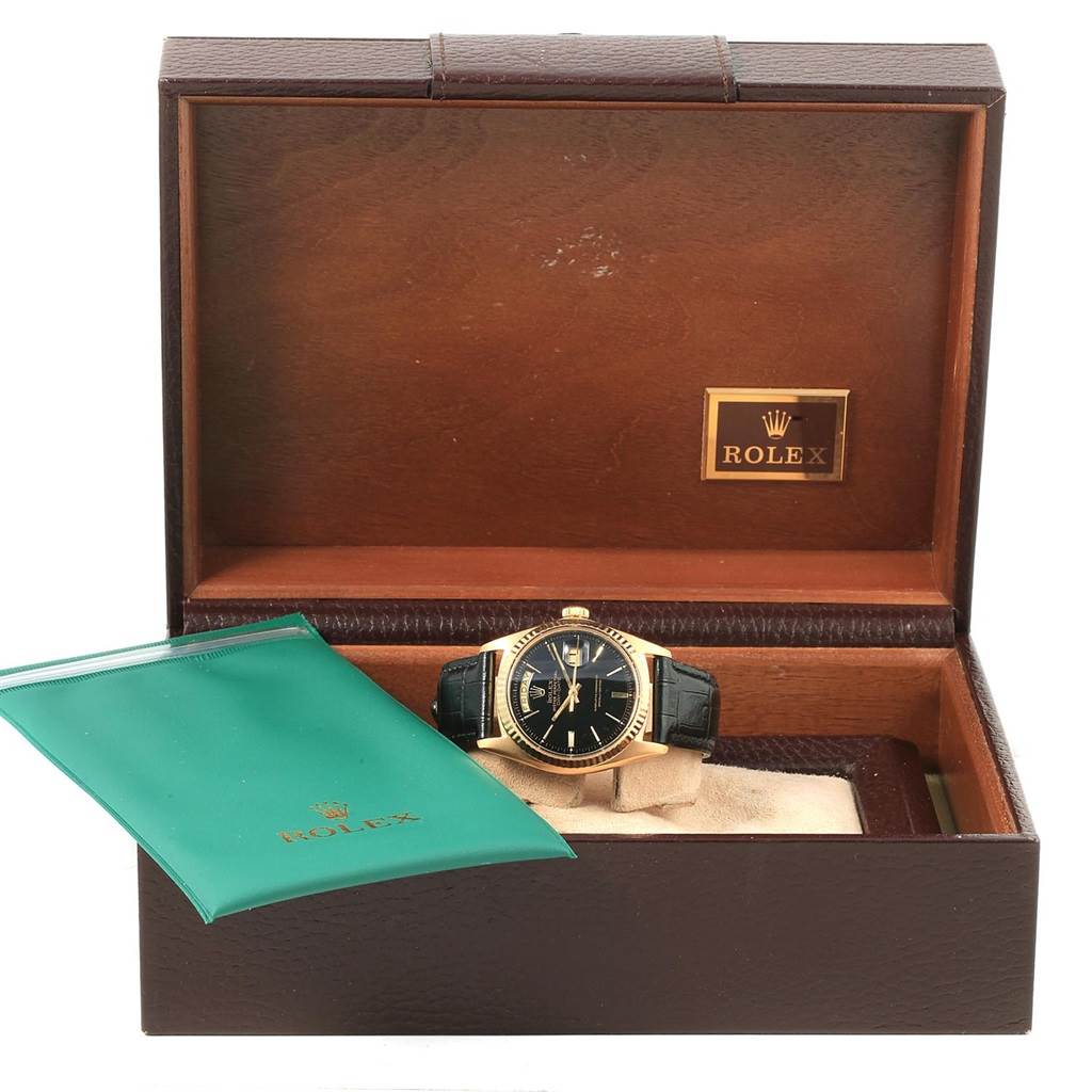This image shows a Rolex Vintage Collection 1803 Men's Yellow Gold Black Dial 1803 Men's Yellow Gold Black Dial watch in its open box, alongside a green Rolex pouch.