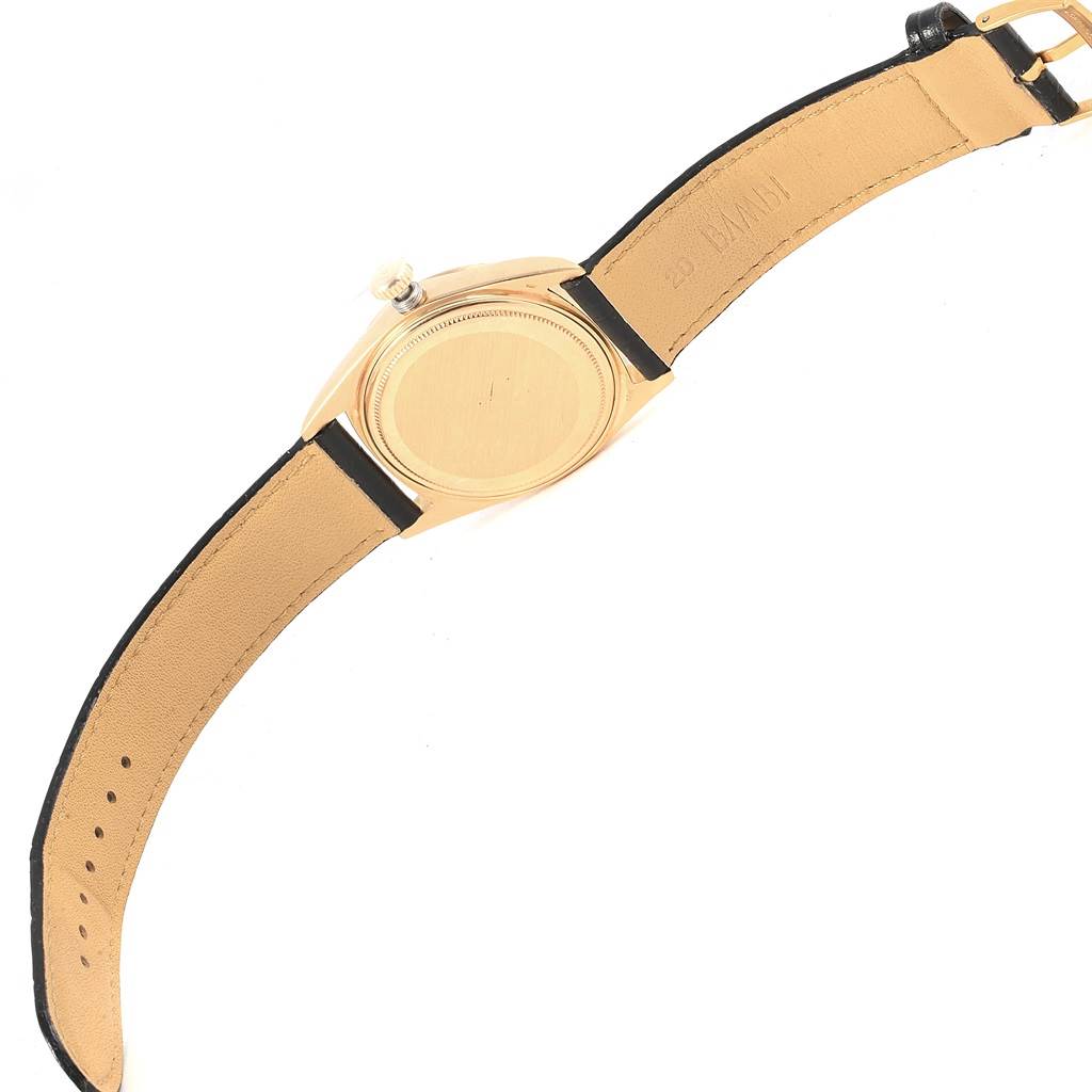 The image shows the back of the case and leather strap of a Vintage Collection model by Rolex.