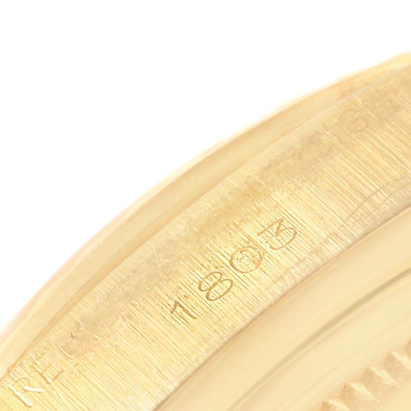 The close-up image shows the side engraving of the bezel on a Rolex Vintage Collection 1803 Men's Yellow Gold Black Dial 1803 Men's Yellow Gold Black Dial model.