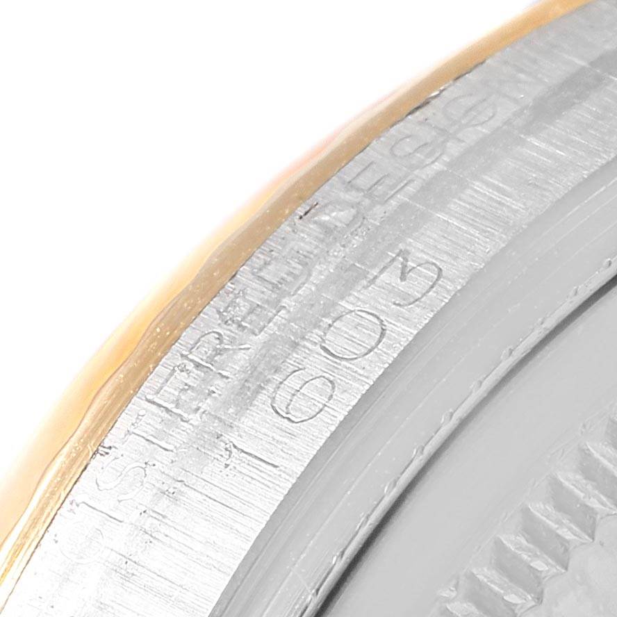 This image shows a close-up angle of the case edge with engravings on the Rolex Vintage Collection 1603 Men's Steel and Gold (two tone) Champagne Dial 1603 Men's Steel and Gold (two tone) Champagne Dial watch.