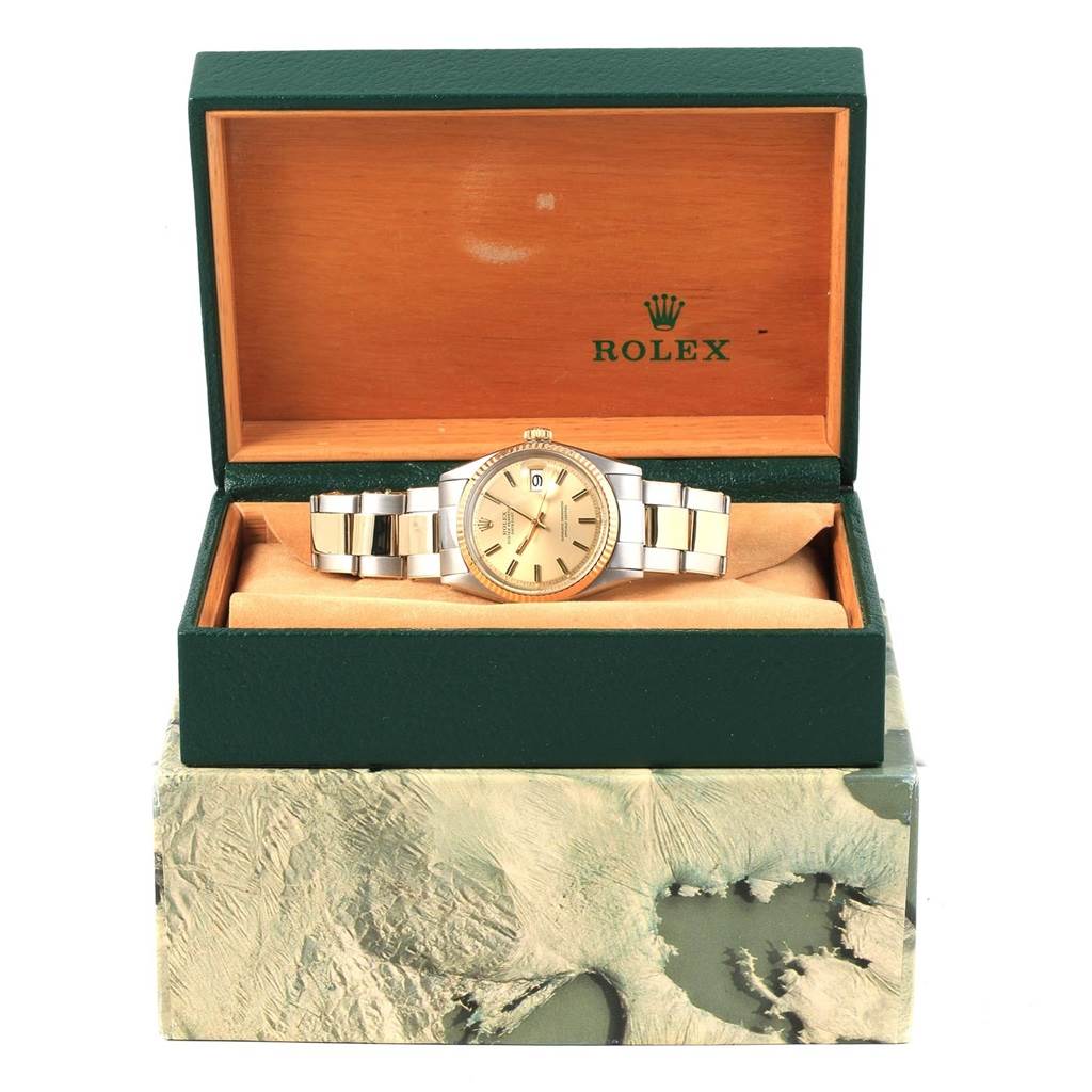 The image shows a Rolex Vintage Collection 1603 Men's Steel and Gold (two tone) Champagne Dial 1603 Men's Steel and Gold (two tone) Champagne Dial watch in a green and wooden display box, viewed from the front.