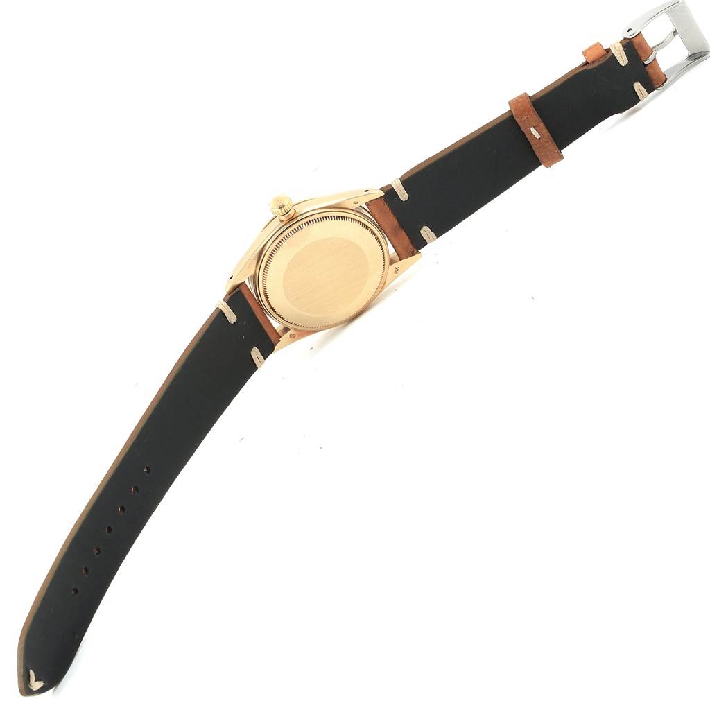 The image shows the back view of a Vintage Collection watch by Rolex, highlighting the watch case and leather strap.
