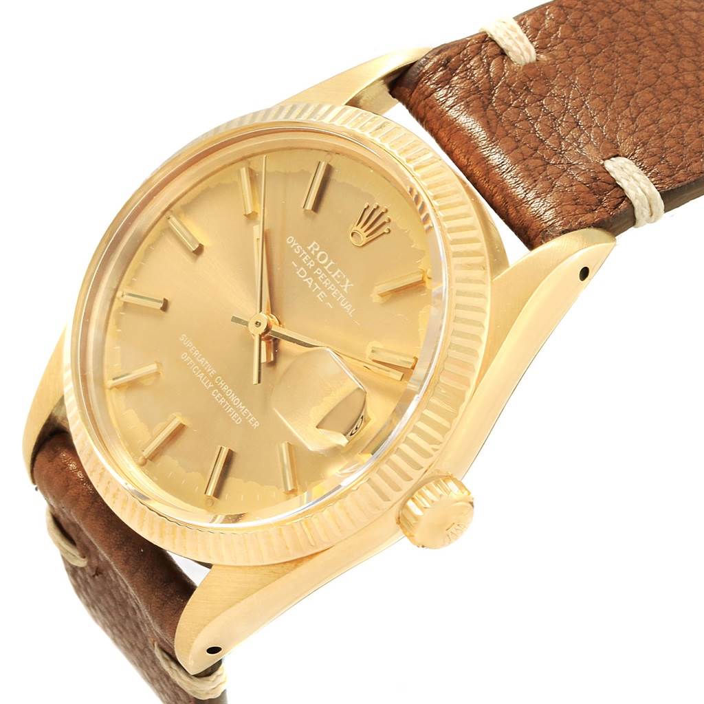This image shows a close-up of a Rolex Vintage Collection 15037 Men's Yellow Gold Champagne Dial 15037 Men's Yellow Gold Champagne Dial watch, highlighting the gold dial, fluted bezel, and brown leather strap.