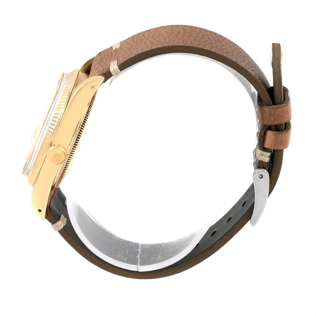 The image shows a side view of a Rolex Vintage Collection 15037 Men's Yellow Gold Champagne Dial 15037 Men's Yellow Gold Champagne Dial watch, highlighting the case, crown, and brown leather strap.