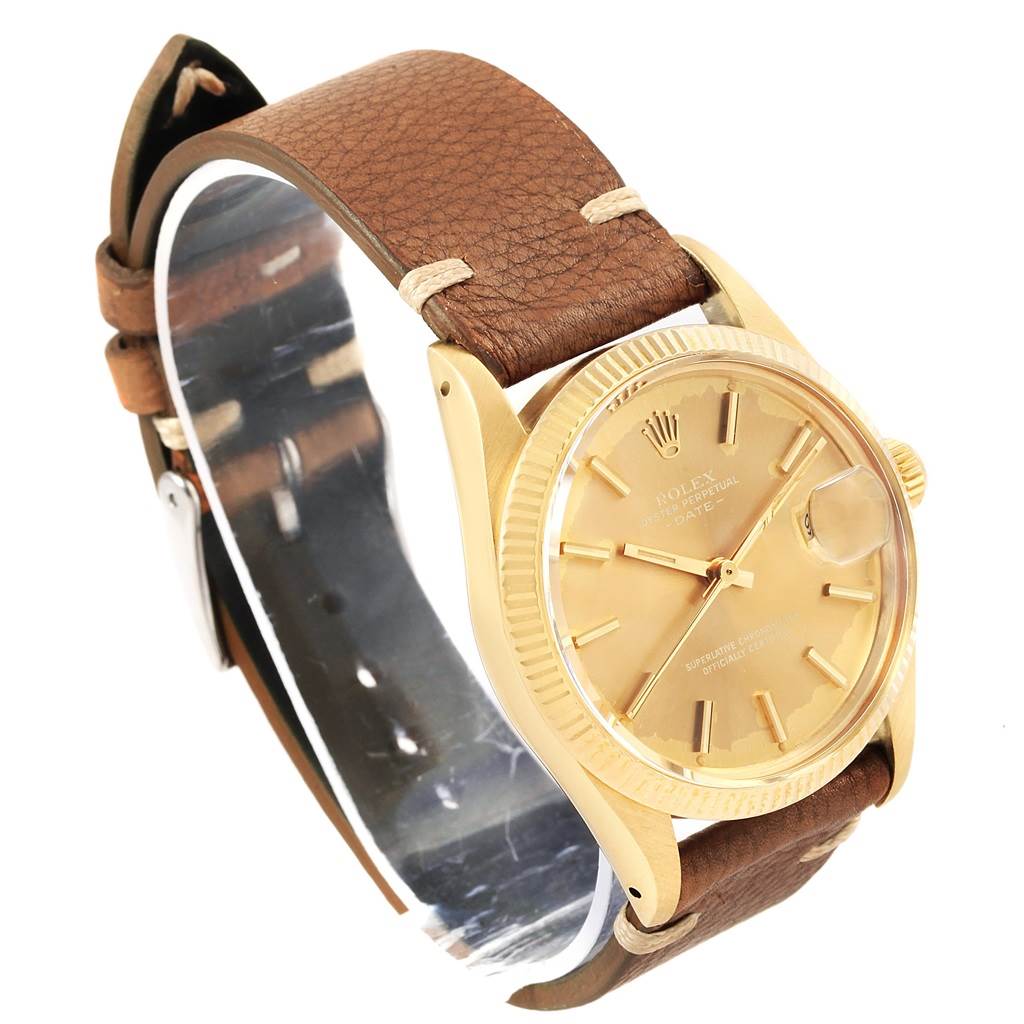 This image shows a side view of the Vintage Collection Rolex watch with a gold dial and brown leather strap.