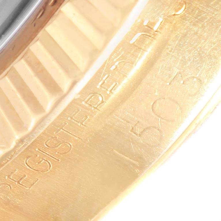 This close-up shows part of the inscribed gold bezel of the Vintage Collection model by Rolex.