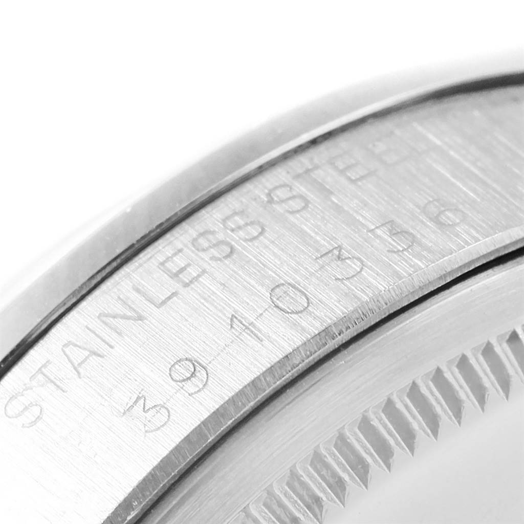 The image shows a close-up of the stainless steel case with engravings on a Rolex Vintage Collection 1501 Men's Stainless Steel Silver Dial 1501 Men's Stainless Steel Silver Dial model.