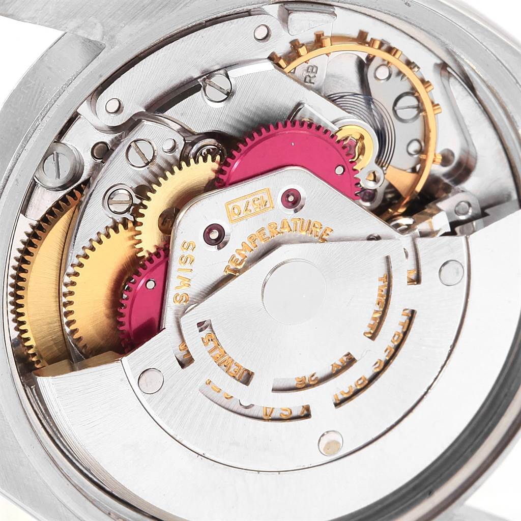 The image shows a close-up view of the intricate inner mechanism of a Vintage Collection Rolex watch.