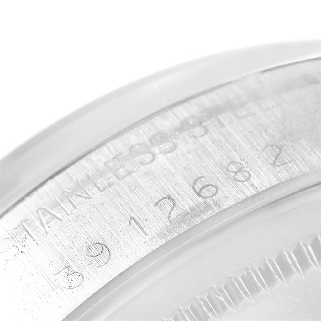 The image shows a close-up of the serial number and stainless steel engraving on the case back edge of a Rolex Vintage Collection 1500 Men's Stainless Steel Grey Dial 1500 Men's Stainless Steel Grey Dial watch.
