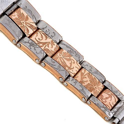 This is a close-up of the bracelet of a Vintage Collection model by Rolex, showcasing a two-tone metal with intricate floral engravings.
