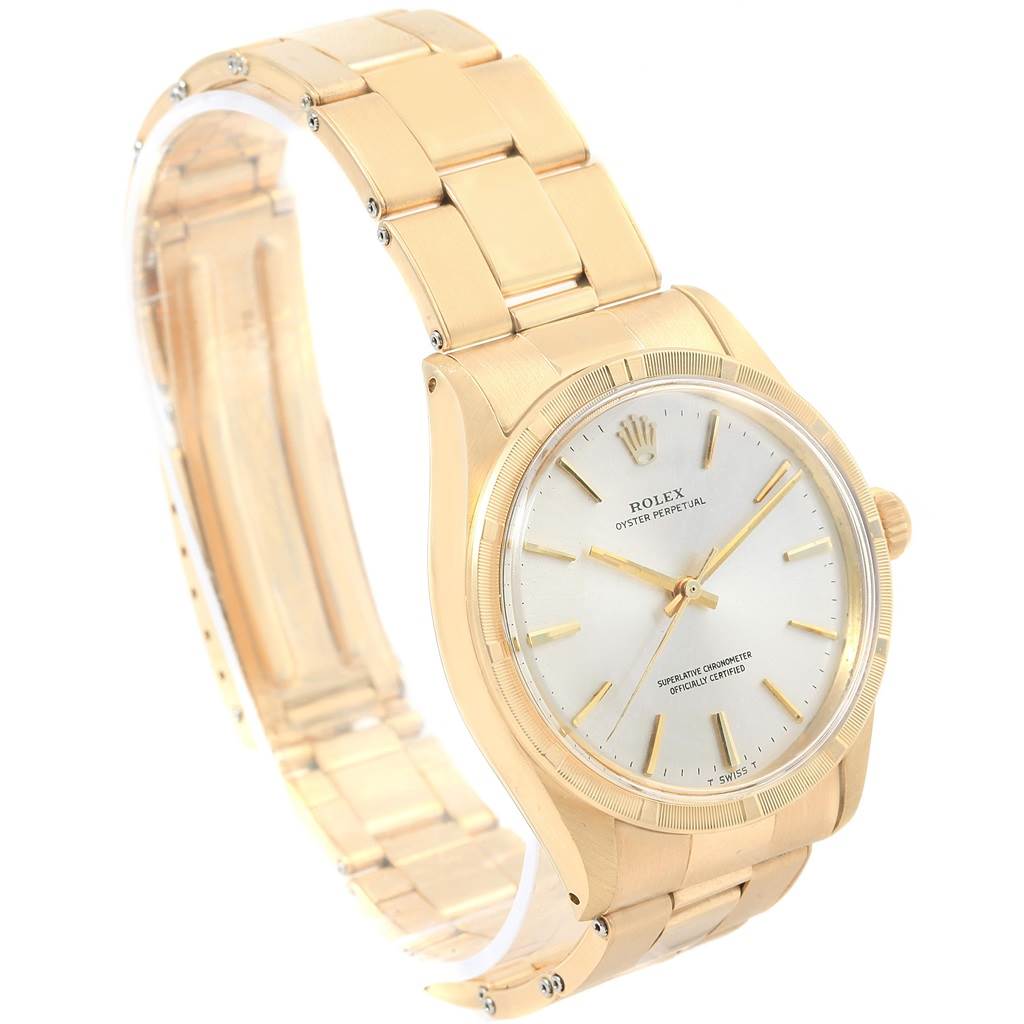 The Rolex Vintage Collection 1007 Men's Yellow Gold Silver Dial 1007 Men's Yellow Gold Silver Dial watch is shown at an angled view, showcasing its golden bracelet, bezel, and dial.