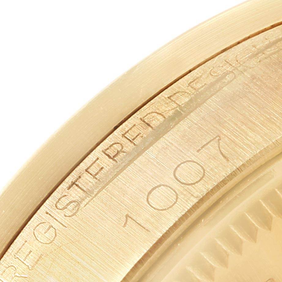 The close-up image shows the edge of the bezel and engraved text on the case of a Rolex Vintage Collection 1007 Men's Yellow Gold Silver Dial 1007 Men's Yellow Gold Silver Dial model.