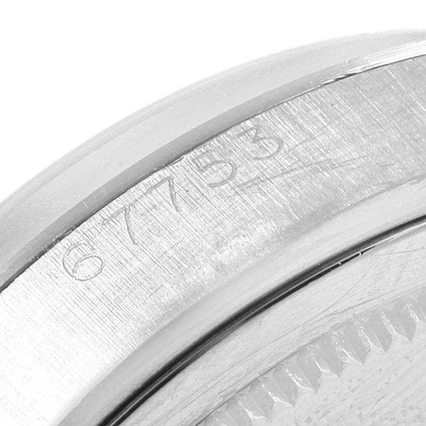The image shows a close-up angle of the serial number engraved on the case of a Vintage Collection model by Rolex.