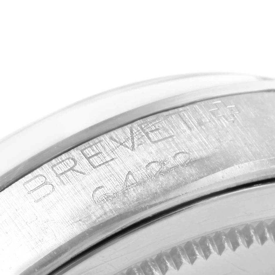 The image shows a close-up view of the side of the Rolex Vintage Collection 6422 Men's Stainless Steel Silver Dial 6422 Men's Stainless Steel Silver Dial watch case, highlighting engraved details.