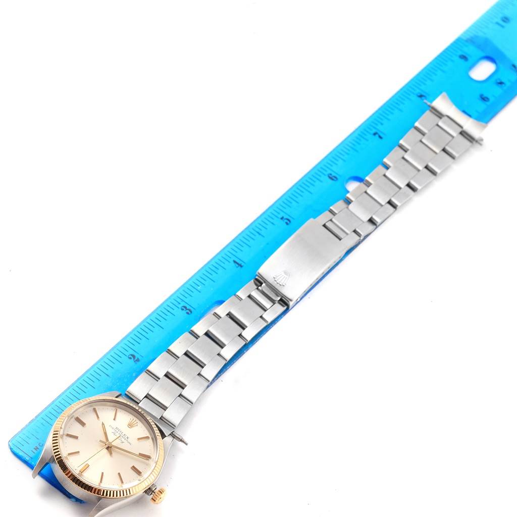 The Rolex Vintage Collection 5501 Men's Steel and Gold (two tone) Silver Dial 5501 Men's Steel and Gold (two tone) Silver Dial watch is shown face-up, lying beside a blue ruler to highlight the length of the bracelet.